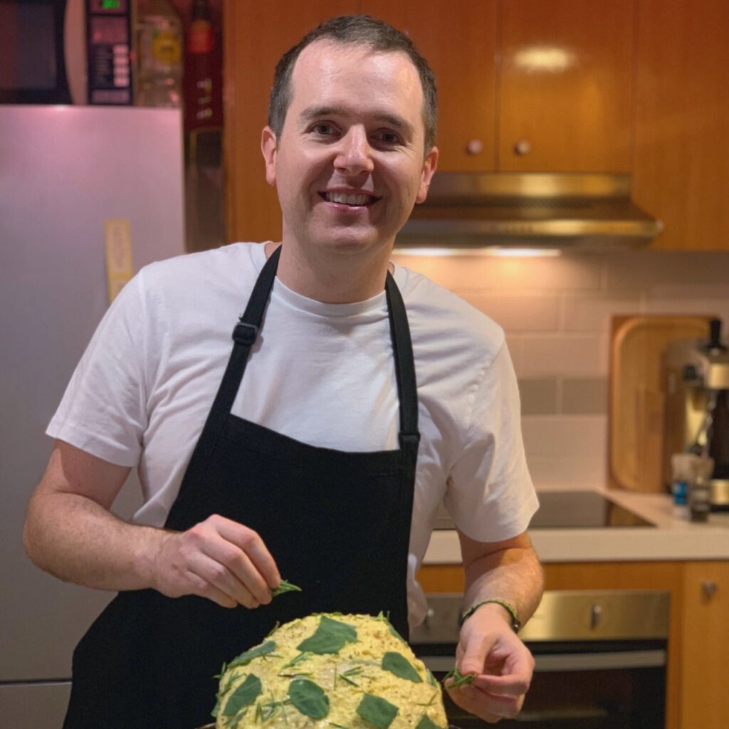 James, the author of Southside Kitchen, placing rosemary on a turkey that is coated in butter in preparation for roasting