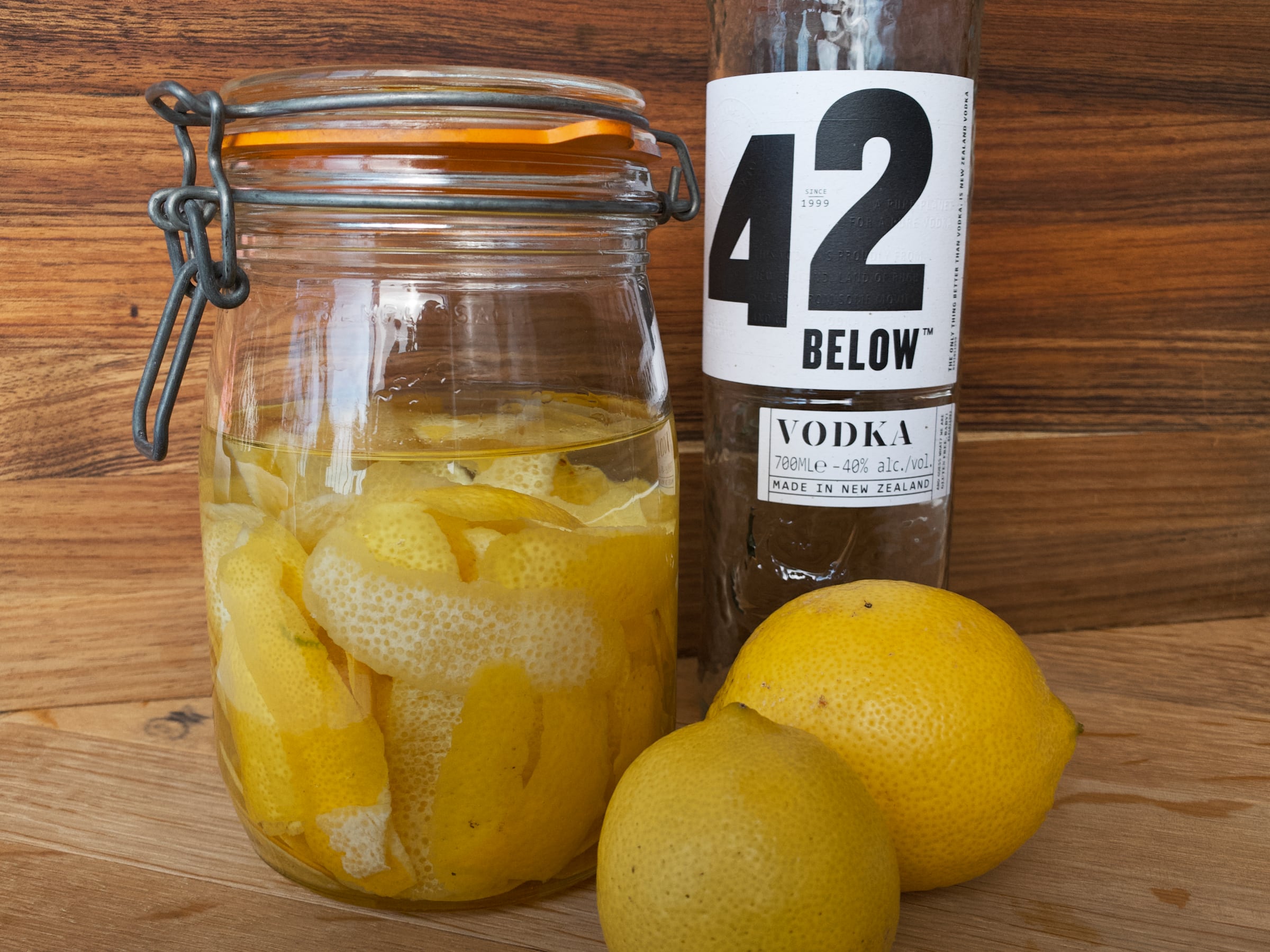 Sealed mason jar filled with lemon peel and vodka