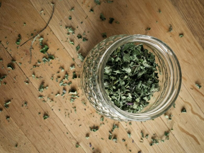 Glass jar filled with dried oregano leaves