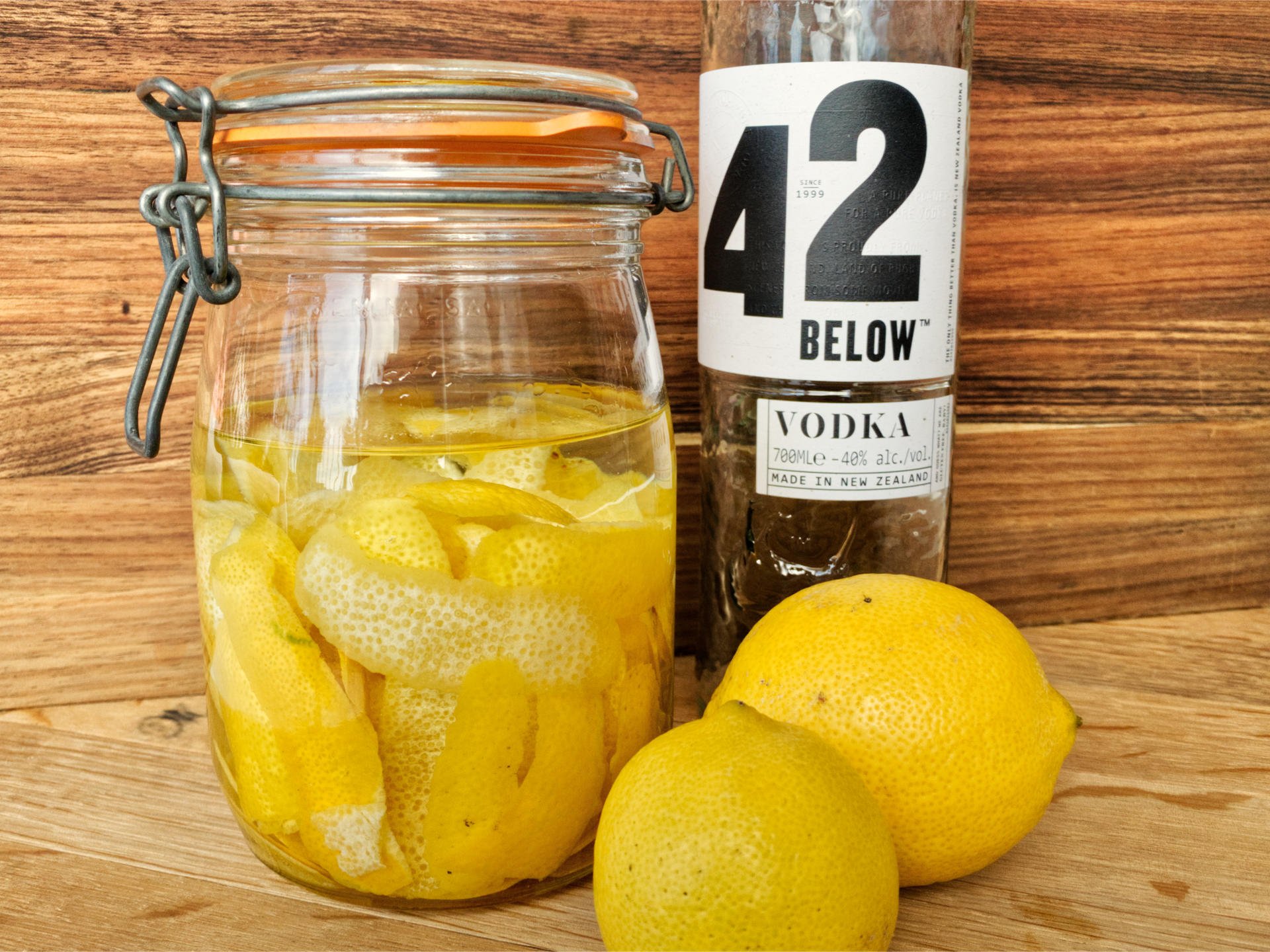 Sealed mason jar filled with lemon peel and vodka