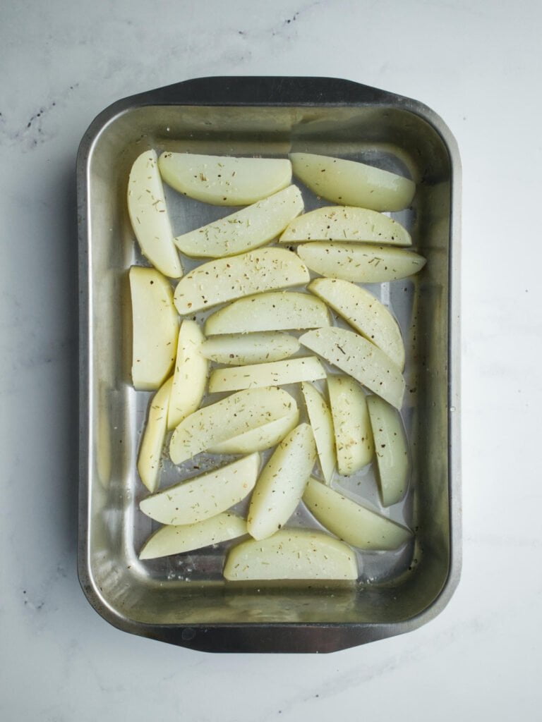 Chips in baking tray ready for the oven