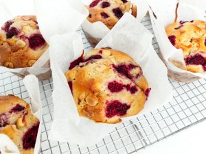 Raspberry and white chocolate muffins cooling on a wire rack