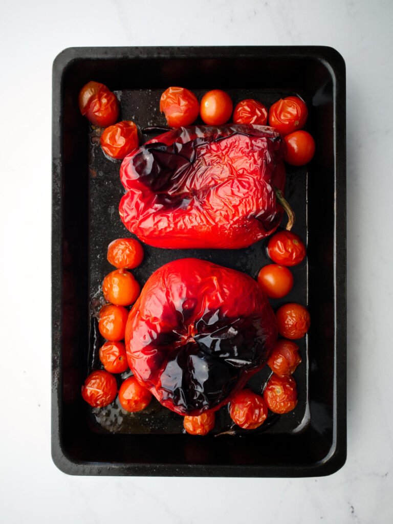 Roasted capsicum and cherry tomatoes in oven tray