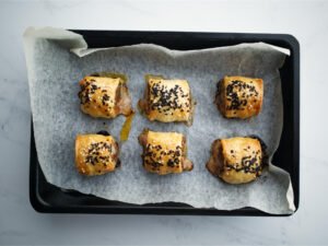 Beef sausage rolls in baking tray