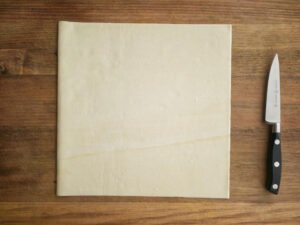Puff pastry sheet laying on flat surface