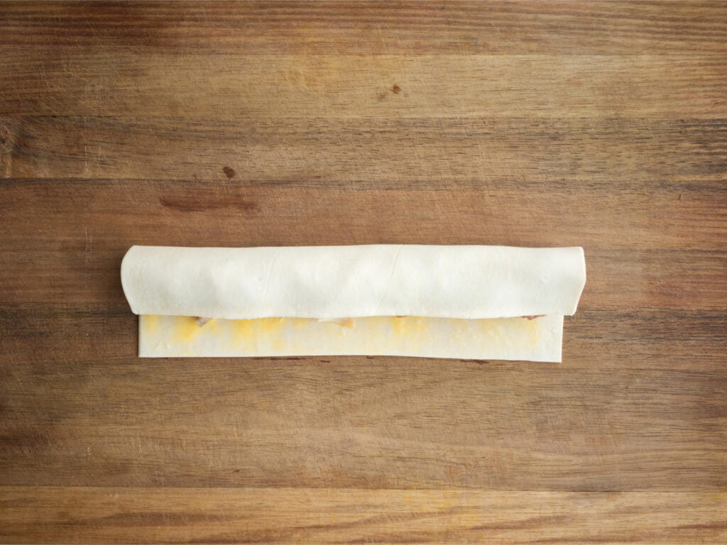 Pastry strip partially rolled up