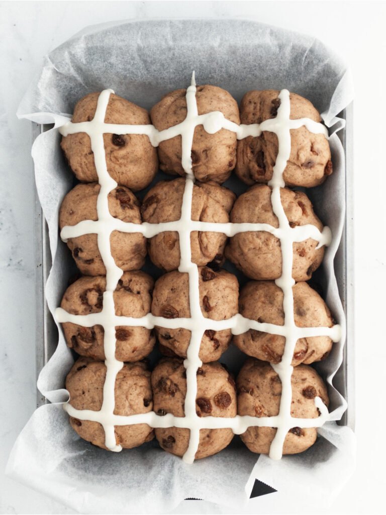 Tray of dough balls coated with white crosses