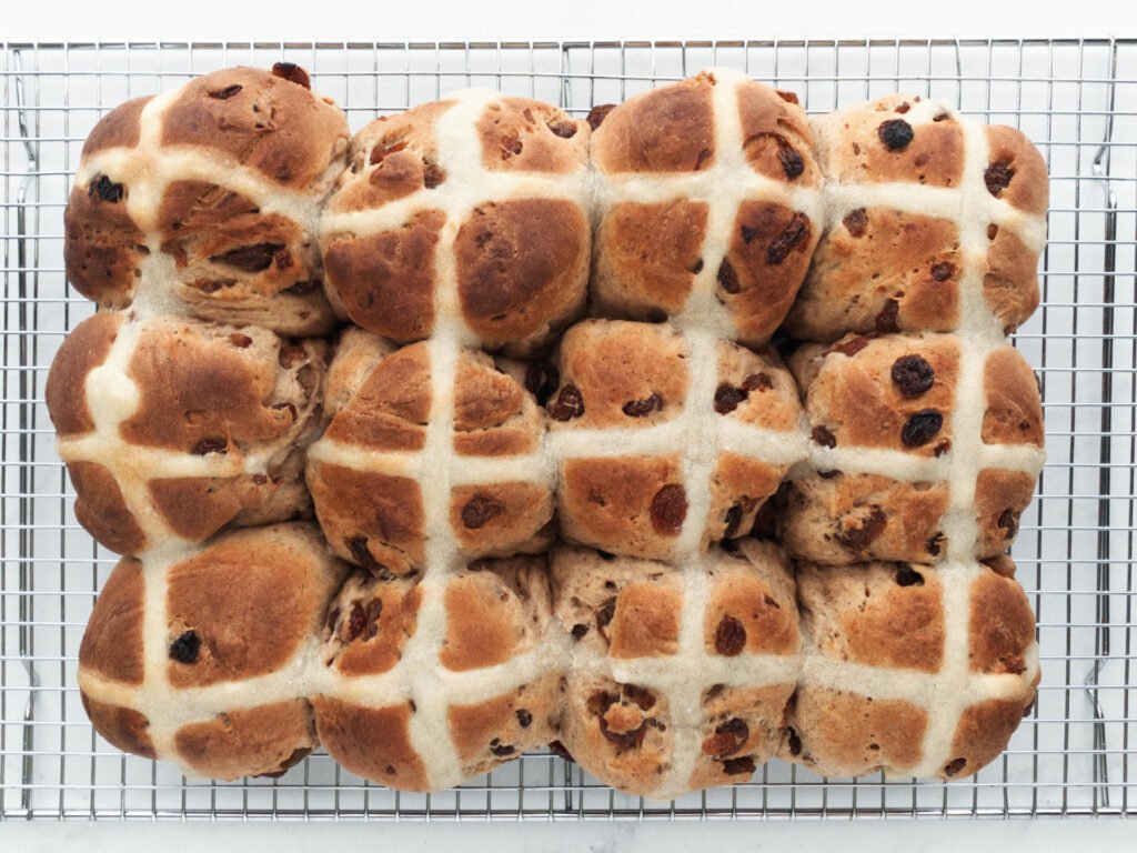 Freshly baked hot cross buns on cooling rack