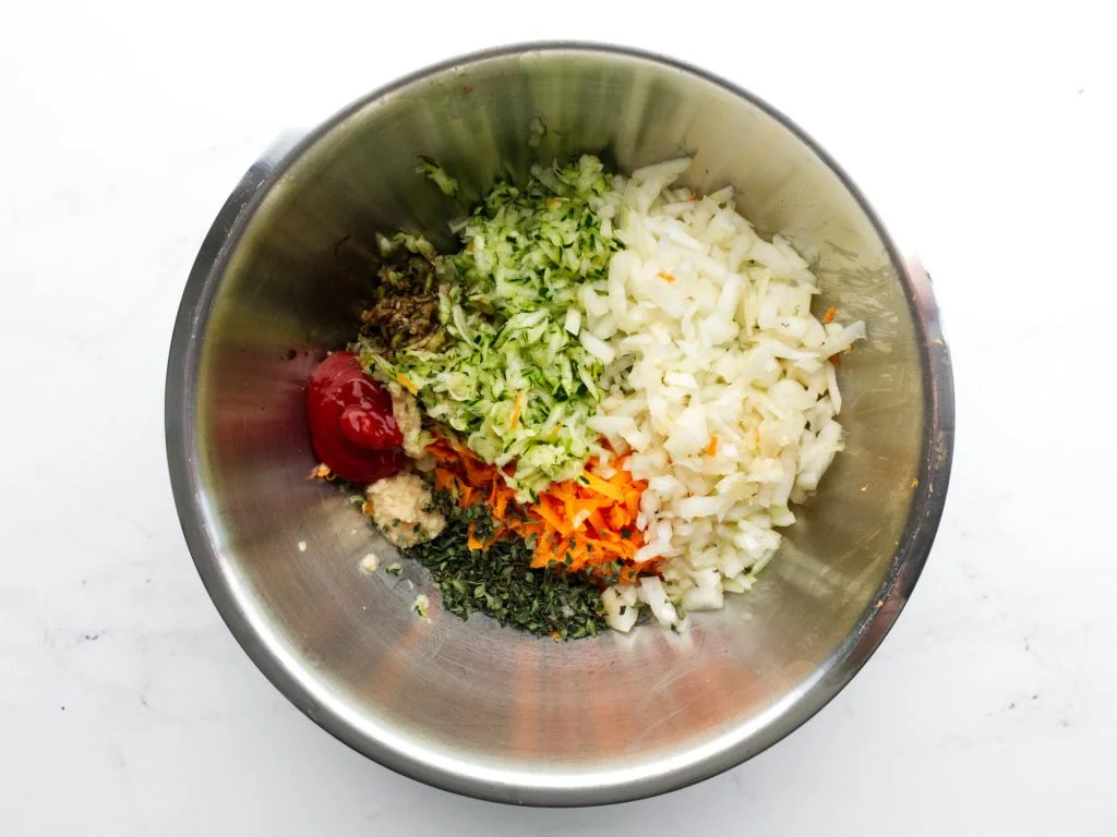 Chicken sausage roll ingredients in mixing bowl