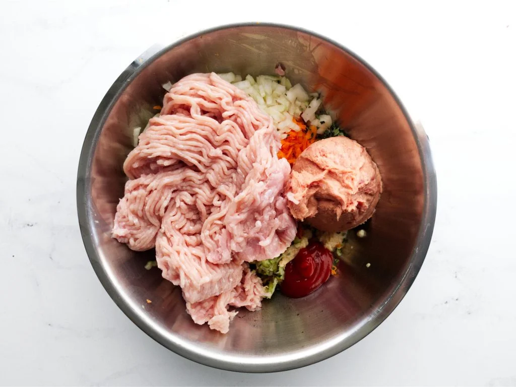 Chicken sausage roll ingredients in mixing bowl