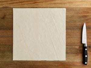 Sheet of puff pastry on cutting board