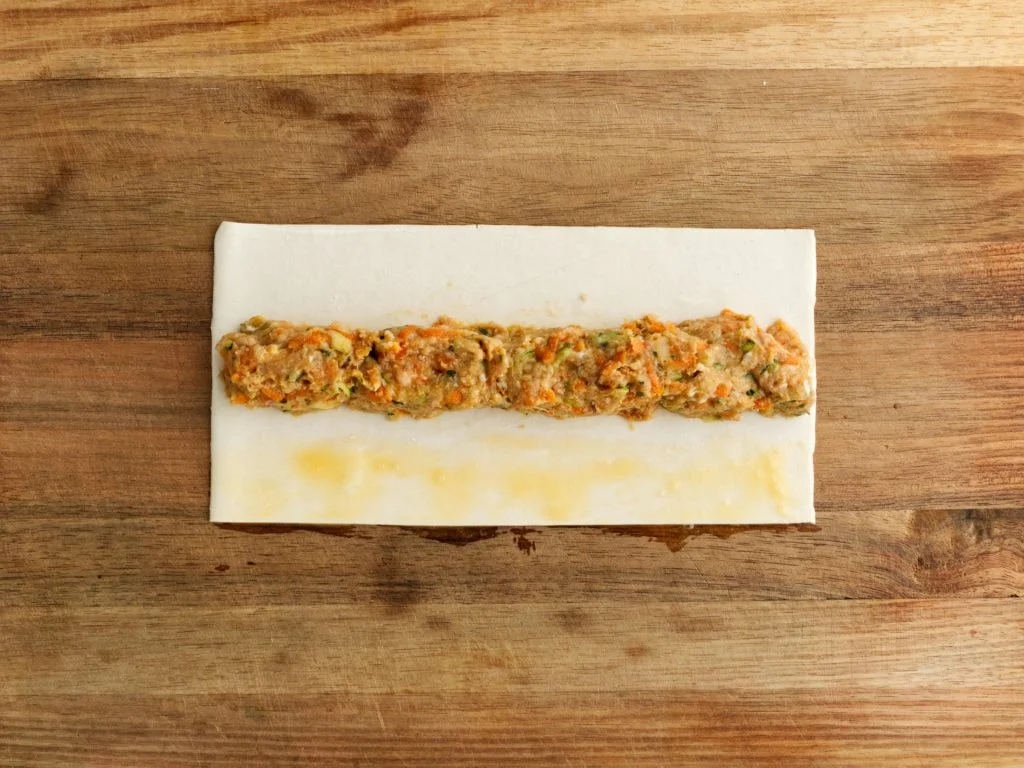 Chicken sausage roll mince on sheet of puff pastry