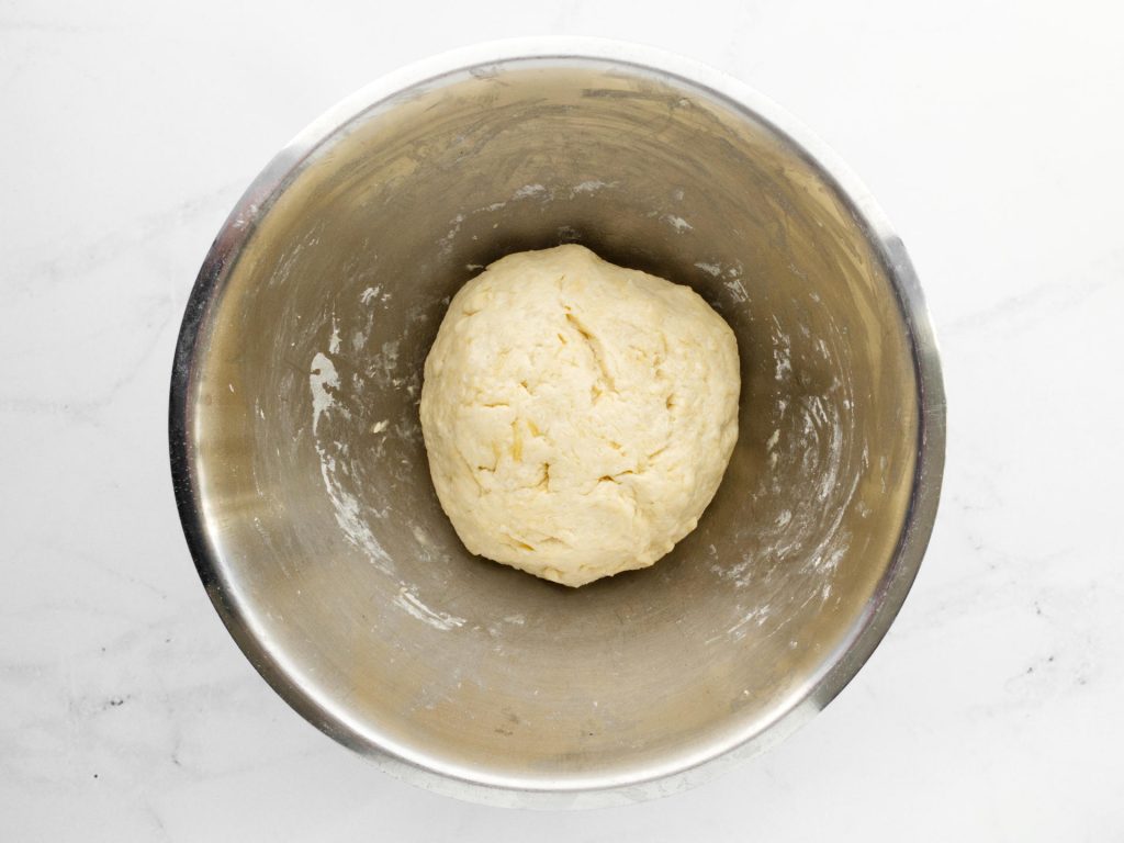 Ball of flatbread dough in mixing bowl.